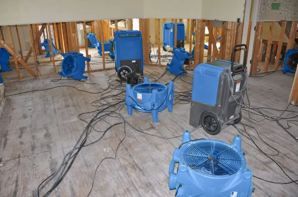 Air movers drying a gutted Seattle room after major water damage